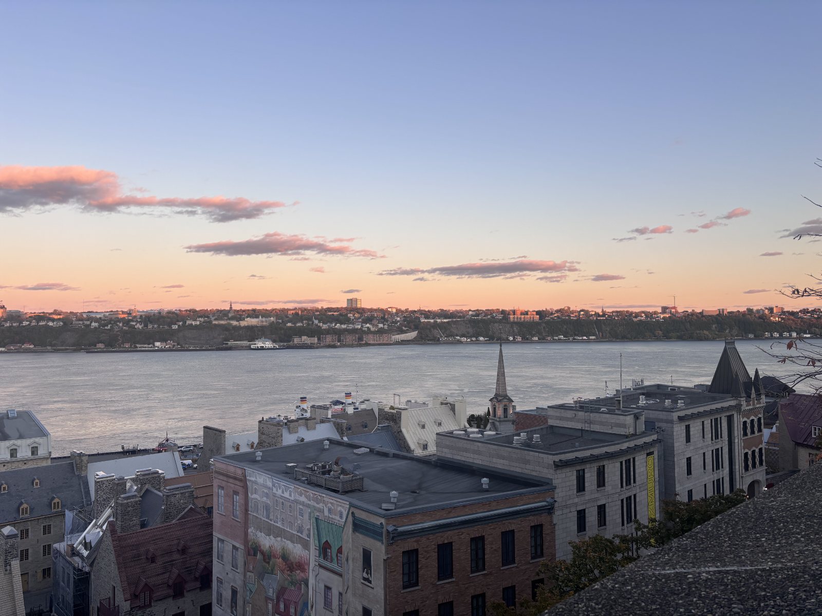 Old Quebec rooftops and the St. Lawrence River at sunset